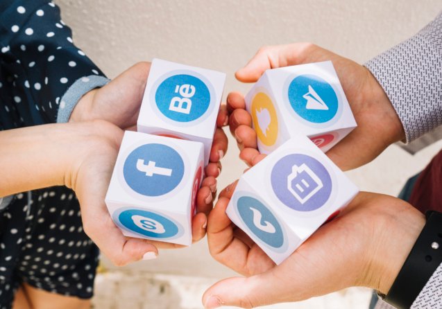 elevated-view-human-hands-holding-blocks-mobile-application-icons