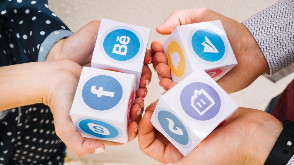 elevated-view-human-hands-holding-blocks-mobile-application-icons